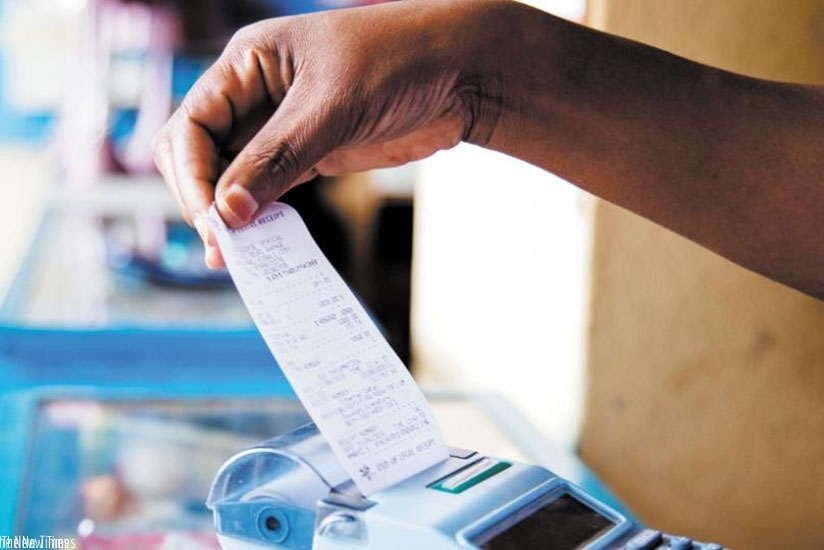 A trader pulls out a receipt from an electronic billing machine. (File)