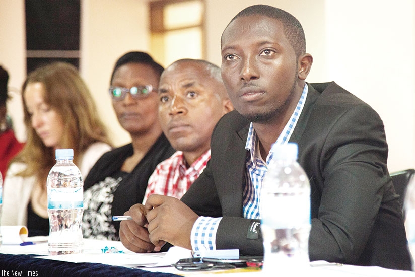 Pontien Nkinzingabo, a resident of Agatare Cell, follows proceedings during the meeting between stakeholders in urbanisation and informal settlement upgrading in Kigali on Wednesday. (Nadege Imbabazi)