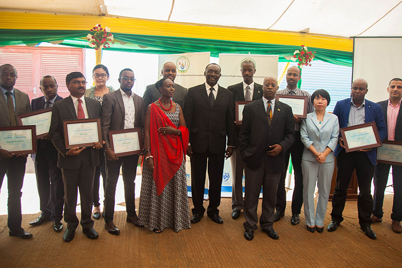 Kanimba (C) poses for a photo with some of the businesspersons who received certificates of appreciation during the ceremony yesterday. / Nadege Imbabazi