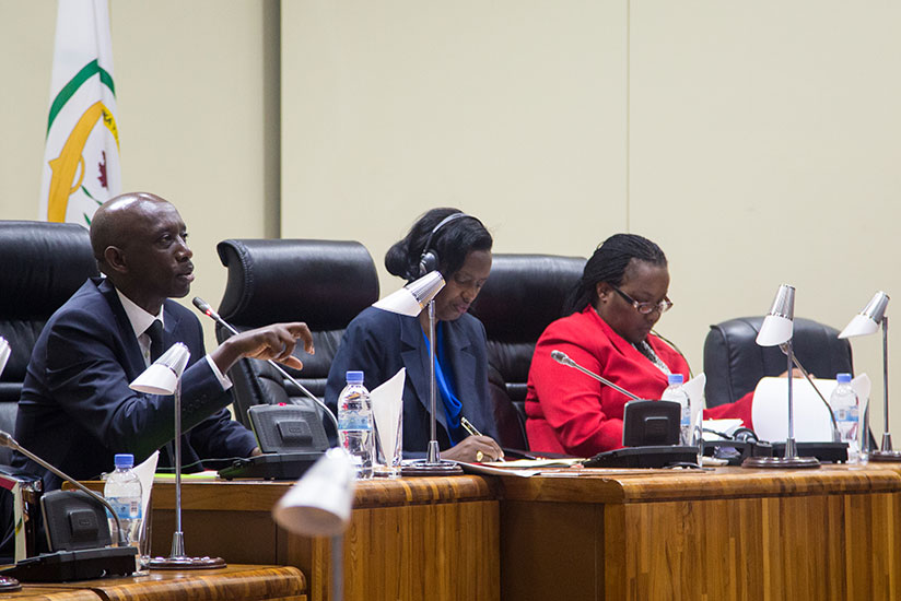 Minister for Local Government Francis Kaboneka (L) speaks yesterday as Agriculture Minister Gerardine Mukeshimana (R) and the chairperson of the Parliament's Standing Committee on Agriculture, Livestock and Environment Ignatienne Nyirarukundo read documents at the Parliament. / Faustin Niyigena