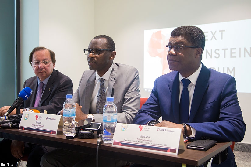 Minister Musafiri (C) speaks to the media yesterday as Distinguished University Professor, University of Ottawa, Prof Howard Alper (L) and Founder and Chairperson of NEF, Thierry Zomahoun, look on. (Photos by Faustin Niyigena)