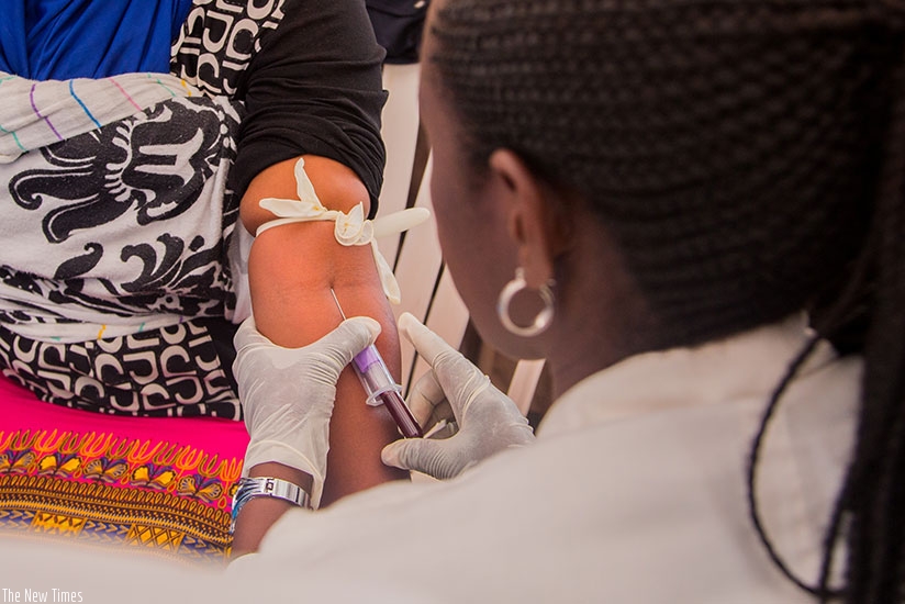 A nurse takes blood sample for an HIV test in Kigali. (Faustin Niyigena)