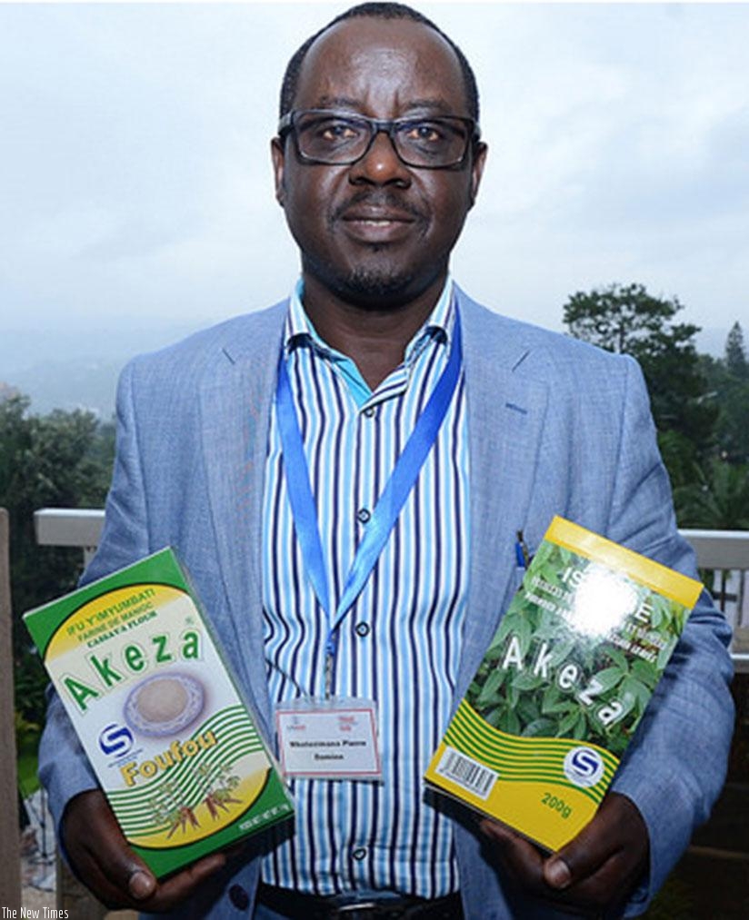 Pierre Damien Mbatezimana, the MD of Shekina enterprises, an agro-processing firm that makes flavoured isombe for export, displays some of the products made by his company. Rwanda has been credited for good business policies . (Donata Kiiza)rn