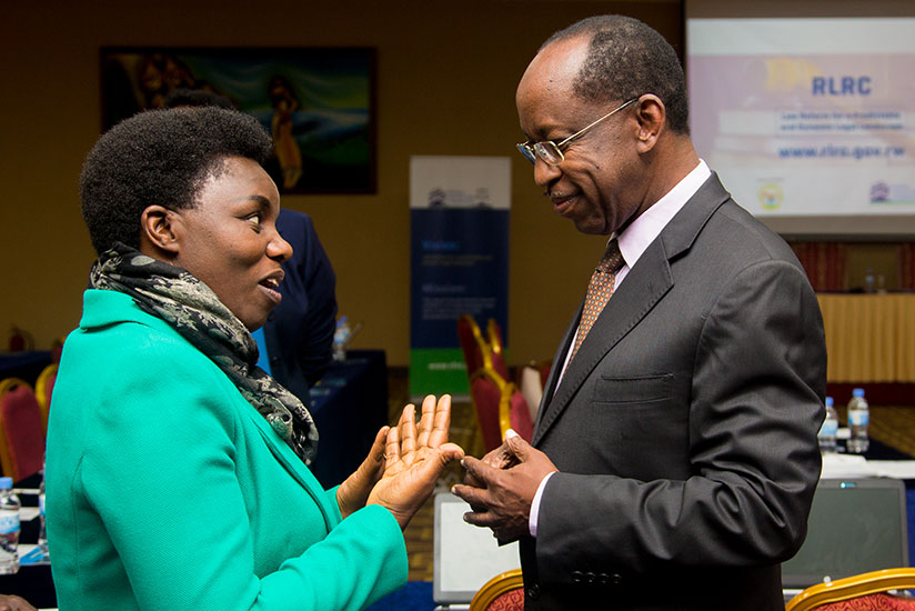 The Minister in President's Office Venantie Tugireyezu chats with the commission's chairperson John Gara yesterday during the launch of the new system at Lemigo Hotel. / Faustin Niyigena