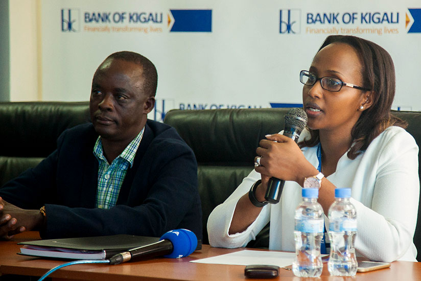 Rose Ngabire, Bank of Kigali's Head of Consumer Banking and Product Development speaks during the launch of Christmas promotion as Konka Managing Director Charles Gasana listens. / Nadege Imbabazi