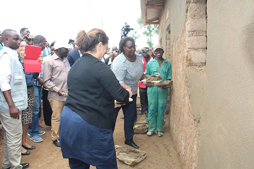 Seraphine Mukantabana, the minister for Disaster Management and Refugees Affairs, and Mehrnaz Mostafavi, the head of Human Security Unit at the UN headquarters joined the community to set a new model village. / Frederic Byumvuhore