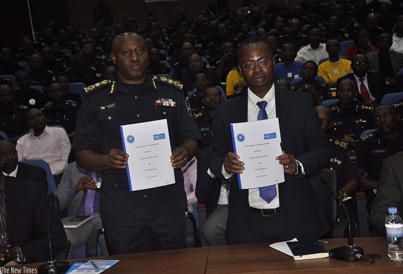 The Inspector General of Police (IGP) Emmanuel K. Gasana and Tigo-Rwanda CEO, Philip Amoateng present the signed MoU. (Courtesy)