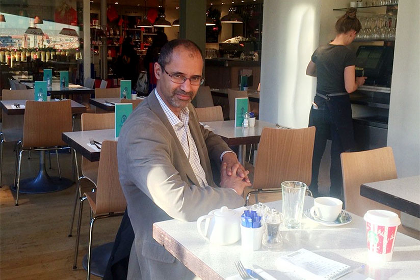 Ilube at his breakfast table in London. / Didier Bikorimana