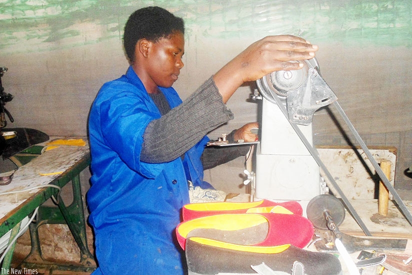 Nikuze on the sewing machine making footwear. (All photos by Remy Niyingize)
