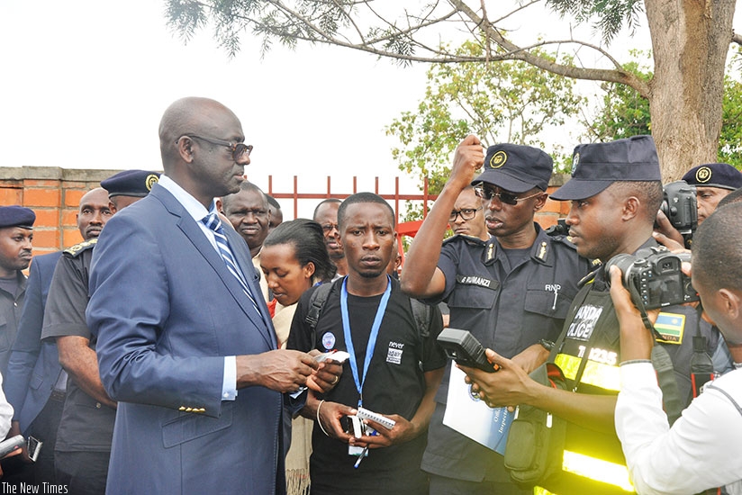The Commissioner for Traffic and Road Safety at Rwanda National Police, George Rumanzi, explains to Justice minister Johnston Busingye  how the new hi-tech traffic control device works. (Courtesy)