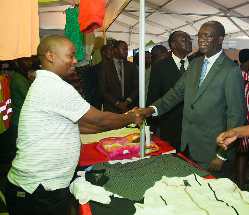 Prime Minister Anastase Murekezi and government officials at a stall for Made in Rwanda clothes yesterday. / Nadege Imbabazi