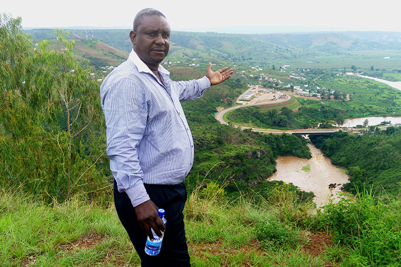 Crispin Kamugisha, from Ngara region in Tanzania, shows the Rusumo Centre. The bridge on Rusumo Falls is seen in the middle. rn(Emmanuel Ntirenganya)