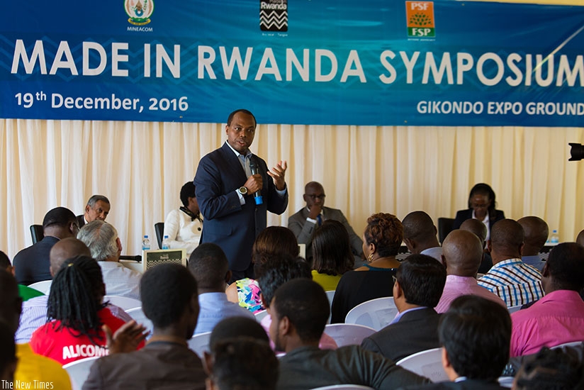 Rwanda Development Board chief executive Francis Gatare speaks to exhibitors of Made-in-Rwanda during the symposium in Kigali yesterday.rnrnTimothy Kisambira.
