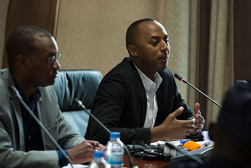 The Chief Operations Officer of Rwanda Development Board (RDB), Serge Kamuhinda, addresses journalists as Parfait Busabizwa, City of Kigali vice mayor for economic development, loo....