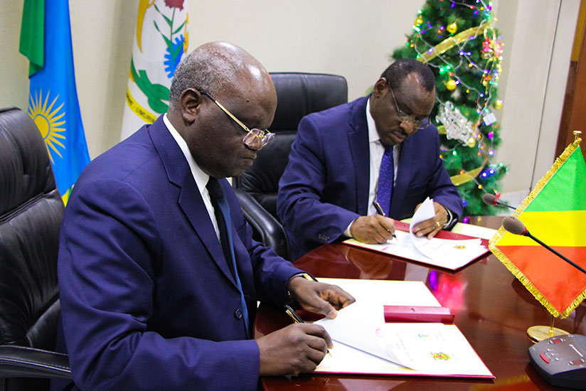 Minister of Finance Claver Gatete (R) and Minister of Labour of Congo Emile Ouosso during the signing ceremony in Kigali. / Nadege Imbabazi