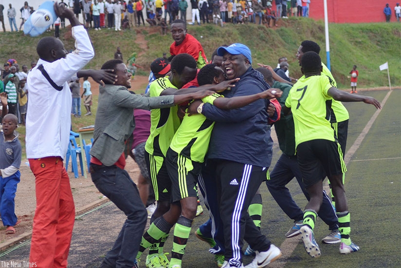 Gicumbi FC players and officials celebrate after they beat SC Kiyovu 4-1 at Mumena stadium. It remains their only win in ten matches. (S. Ngendahimana)