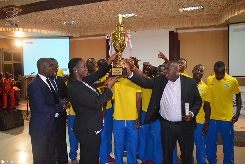 Sports and Culture Minister Julienne Uwacu (L) receieves the trophy that the national handball team won recently in Uganda (S. Ngendahimana)