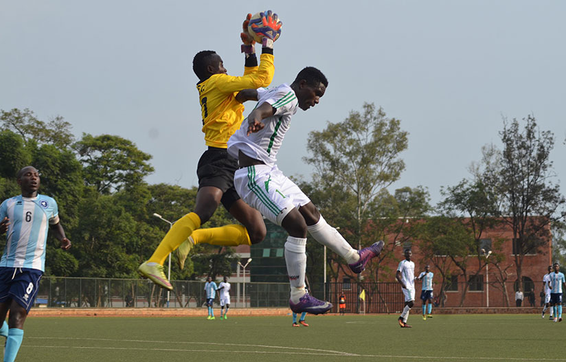 Police FC goalie Emmanuel Bwanakweli catches the ball as SC Kiyovu's brace scorer Jean-Claude Nizeyimana wants to net another goal. / Sam Ngendahimana