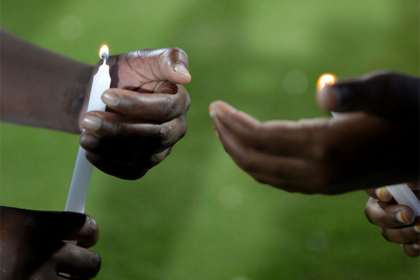 Children light candles at Amahoro Stadium during the Genocide commemoration in 2014. / File
