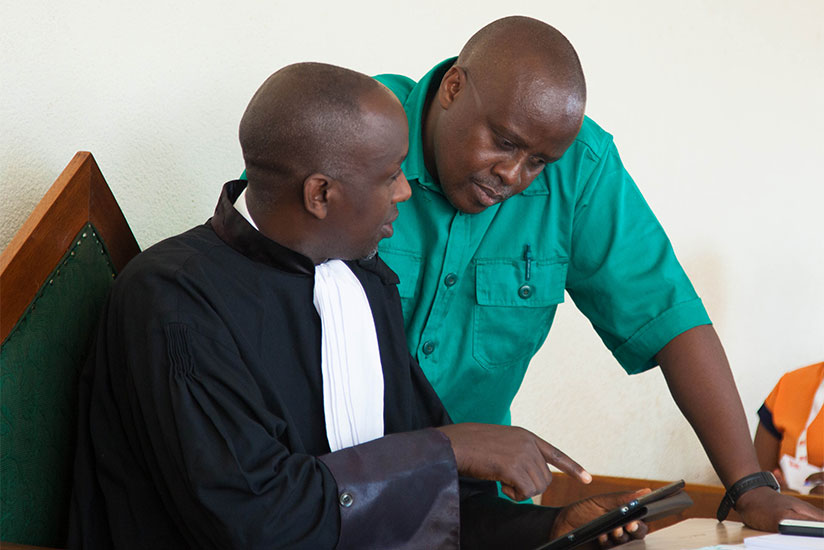 Seyoboka consults with counsel Ngirabatware at the Military Tribunal yesterday. / Nadege Imbabazi