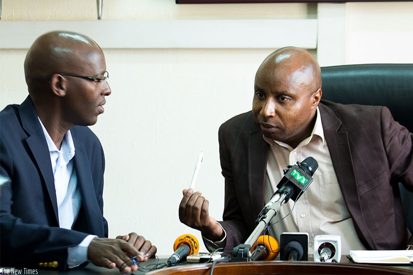 Mugiraneza (R), the Rwanda Energy Group chief executive chats with Eng. Jean Claude Kalisa, the managing director of Energy Utility Corporation Ltd, during the news conference yest....