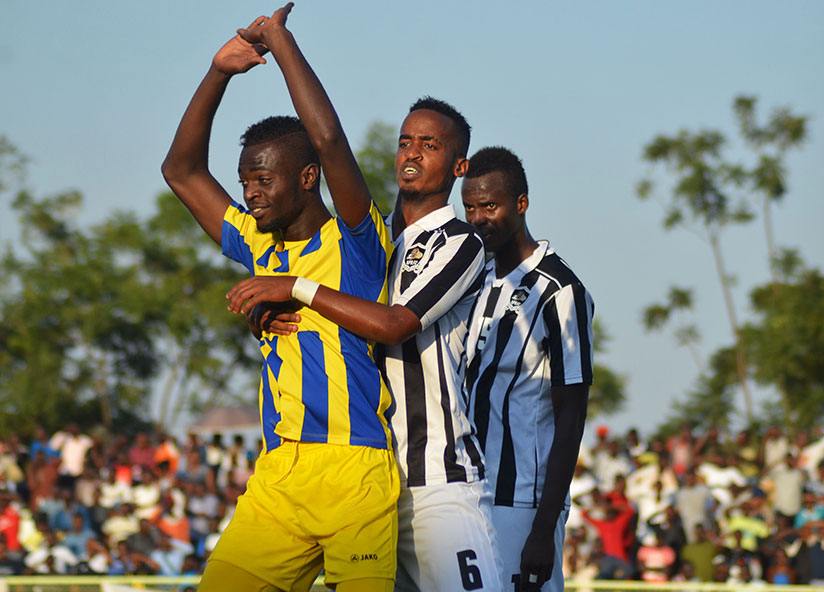 AS Kigali striker Bernabe Mubumbyi is blocked by APR FC midifielder Yannick Mukunzi during the match on Saturday at Kigali Regional Stadium. / Sam Ndendahimana
