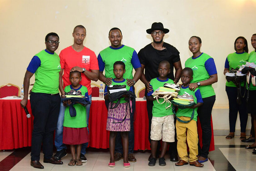 The Ben (in hat) and other members of Light my Candle organisation in a group photo with the children who were supported. / Francis Byaruhanga