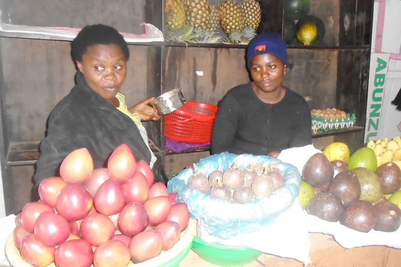 Aline Uwimana (Right) sells fruits at her stall in Kimironko market. (Photos by L. Atieno)
