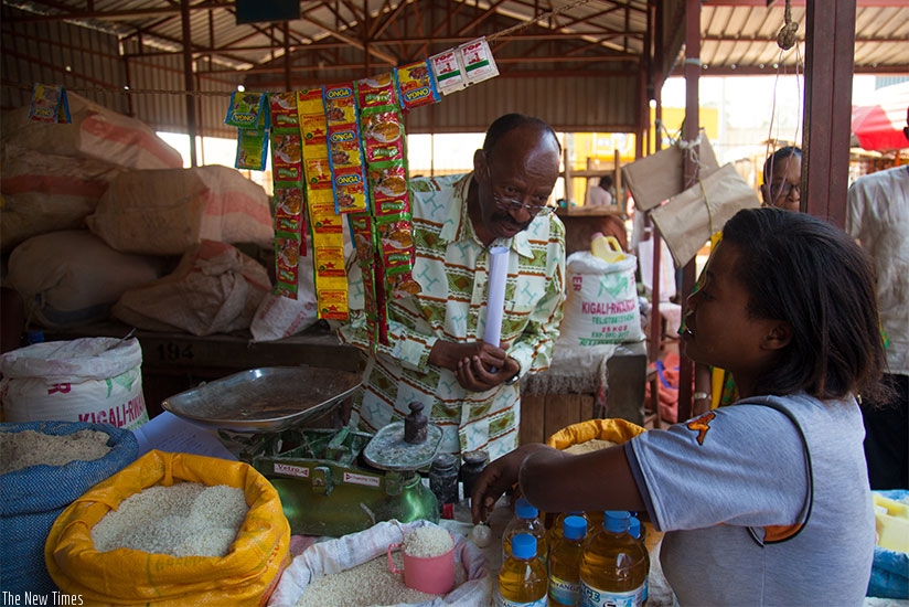MP Emmanuel Mudidi speaks to a salesperson at Gahanga market. Timothy Kisambira.