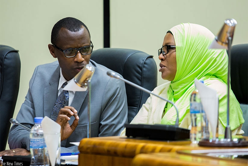 Minister Musafiri chats with Senate vice president Fatou Harerimana at Parliament where he was presenting the bills. File
