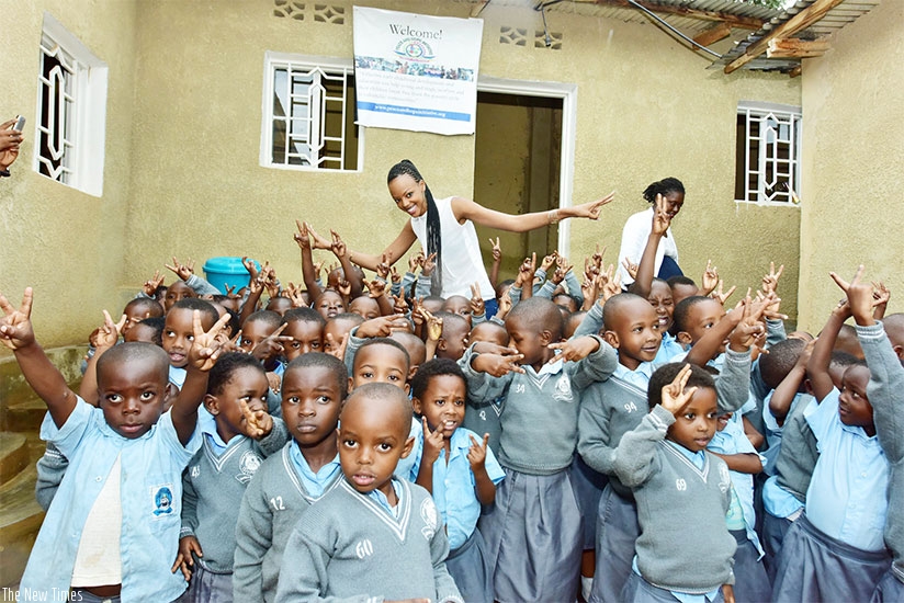 Mutesi strikes a pose with children of Kinyinya Nursery School. 