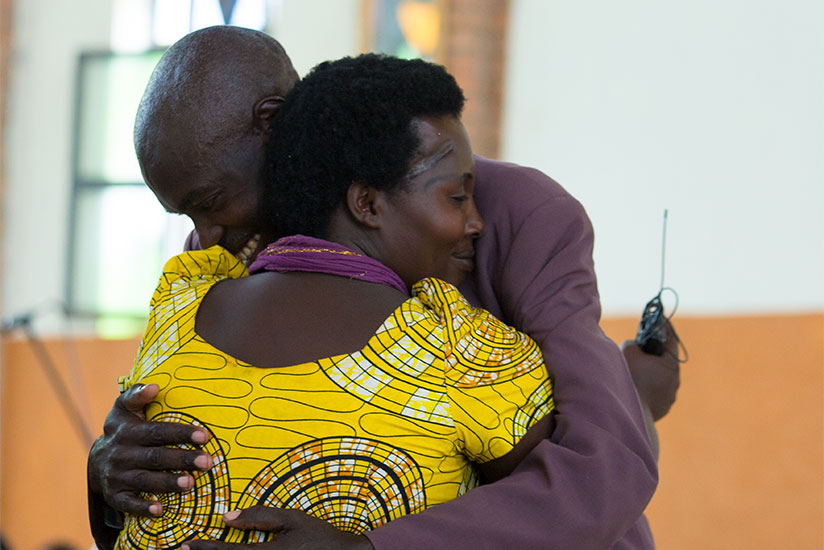 Claudette Mukamanzi, a Genocide survivor, hugs Jean-Claude Ntambara, ex-Genocide convict, after forgiving him at Nyamata Parish last Sunday. / Timothy Kisambira