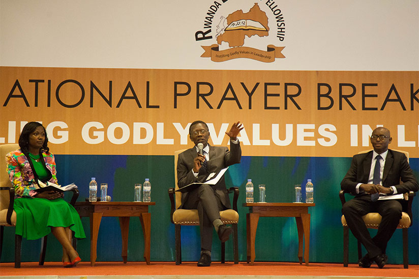 Pastor Antoine Rutayisire (C) speaks during the Young Leaders Conference as Dr Charity Wibabara (L) and Brig Gen Emmanuel Bayingana looks on. / Nadege Imbabazi