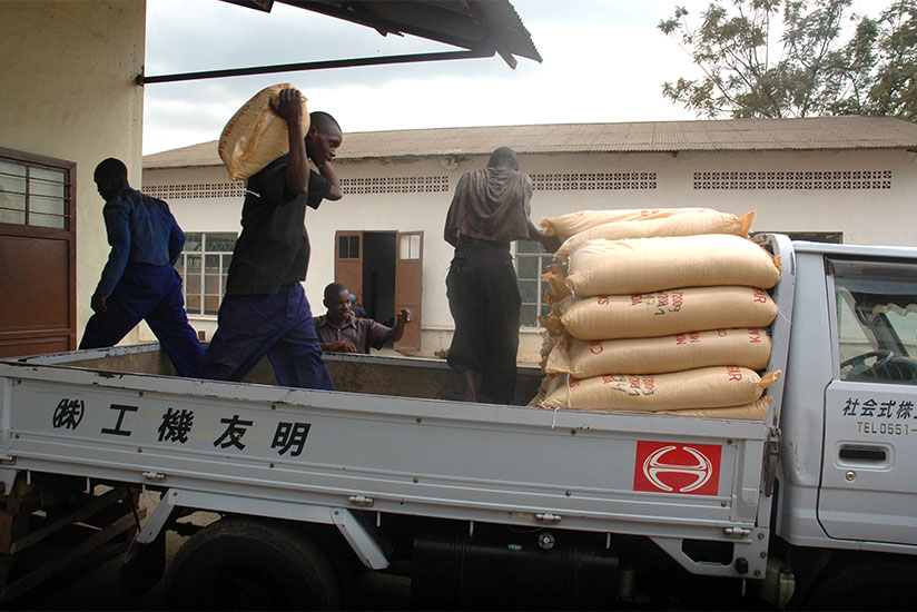Workers at Kabuye sugar factory load sacks of  sugar on a truck. / File