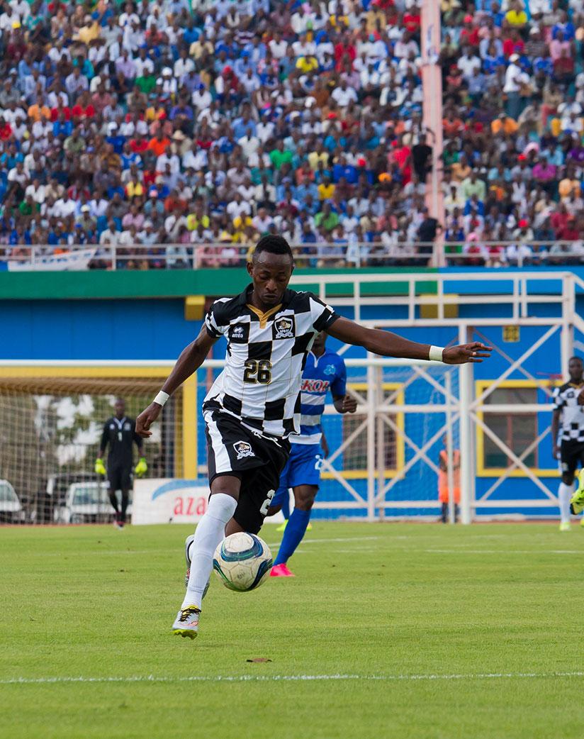 APR striker Issa Bigirimana takes a shot at goal during yesterday's league game against Rayon Sports. He scored the only goal for APR. / Timothy Kisambira.