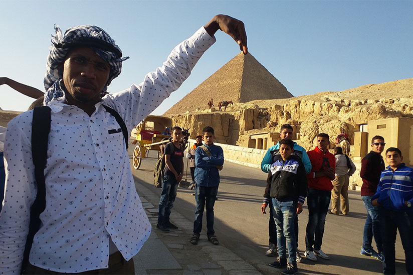 The writer poses for a photo at the pyramids.