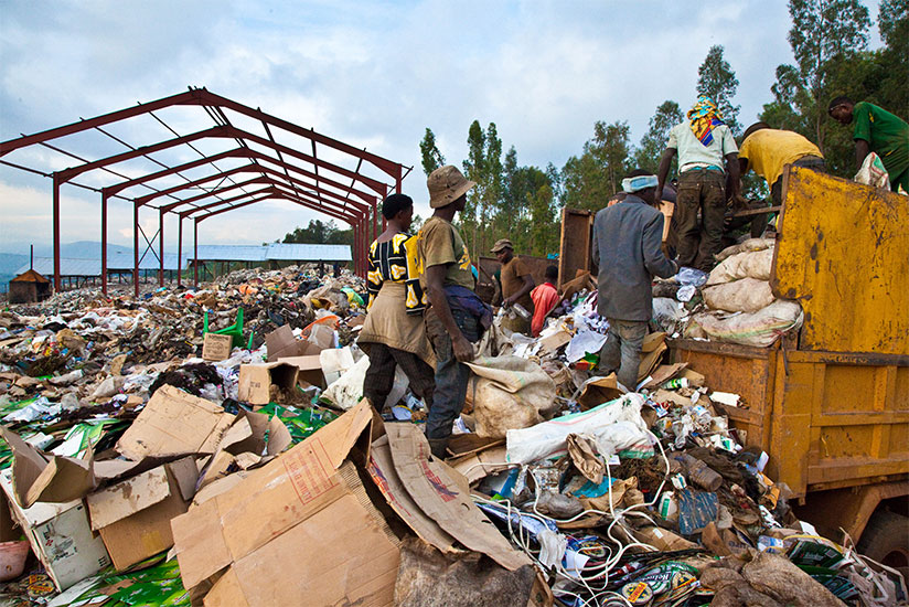 Workers at Nduba dump site in Gasabo District sort out garbage. City of Kigali is keen to fight waste dumping in the city. / Timothy Kisambira 