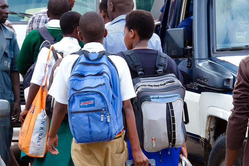Students at Nyabugogo bus terminal carry their bags, as they headed back to school at the weekend. Heads of schools have been urged to respect the school calendar as the new academ....