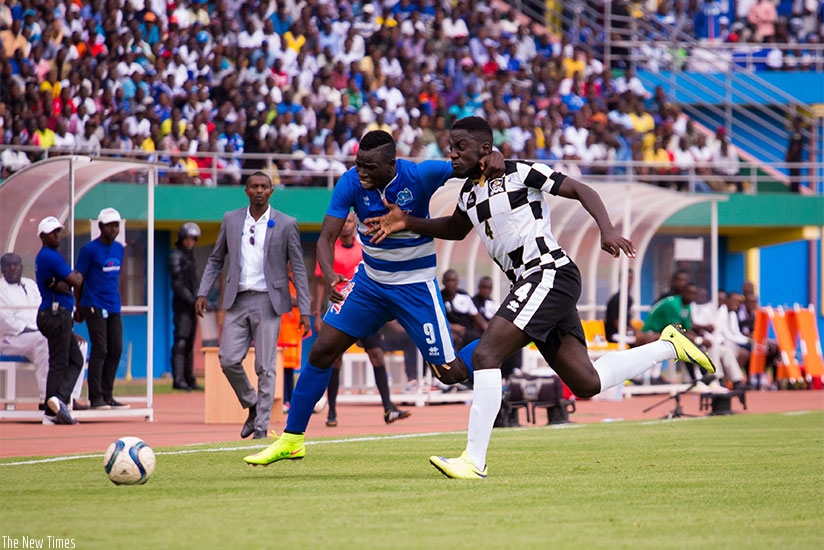 Rayon Sports  striker Moussa Camara battles with APR defender Herve Rugwiro during a league game on Saturday. / Timothy Kisambira.