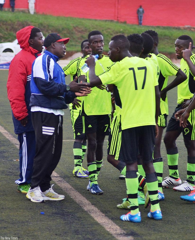 Gicumbi FC coach Hussein Baraka (left) speaks to his players during the league match against Kiyovu, which Gicumbi  won 4-1 on match day 3. (S. Ngendahimana)