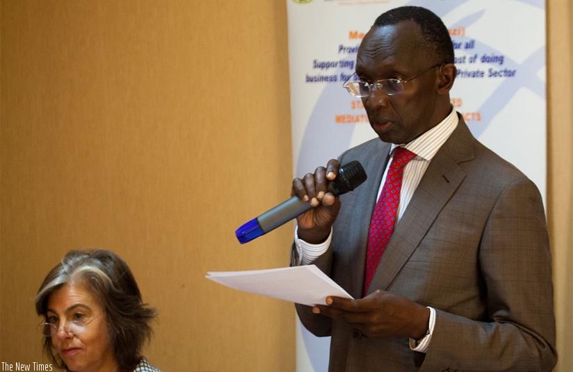 Chief Justice Sam Rugege (R) gives his remarks as Emily J. Gould, Esq Co-director, African Peace partners, looks on in Kigali. Timothy Kisambira.