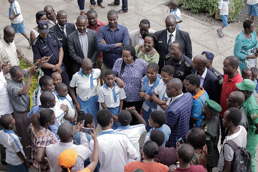 Nyirasafari (C) chats with children with hearing impairment at Ubumwe community centre yesterday. / Donata Kiiza.