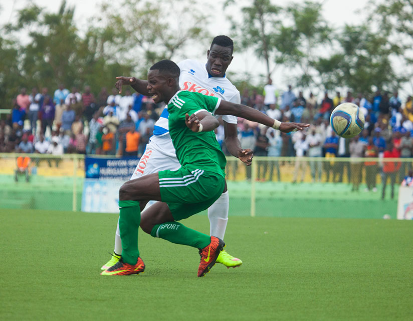 Rayon Sports' striker Moussa Camara, who scored the first goal, vies for the ball with SC Kiyovu defender Mukamba Namasobwa during the match at Nyamirambo regional stadium yesterda....