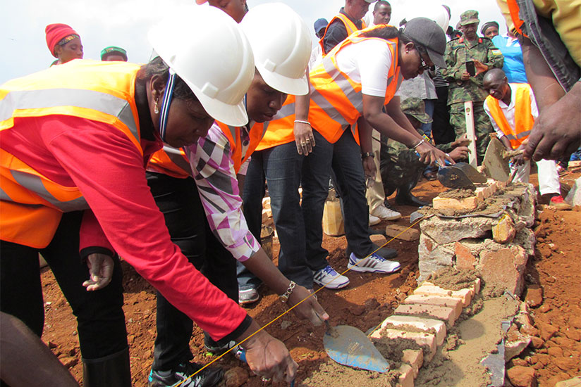 From L-R: Dr Nyirahabimana, Uwamariya, and Mukaruliza lay the foundation stone for the construction of housing units for vulnerable residents in Kicukiro District during Umuganda o....