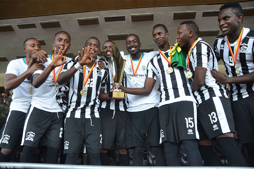 APR FC players hold the trophy to celebrate the crucial win against archirivals Rayon Sports 1-0 at Amahoro . (All photos by Sam Ngendahimana)