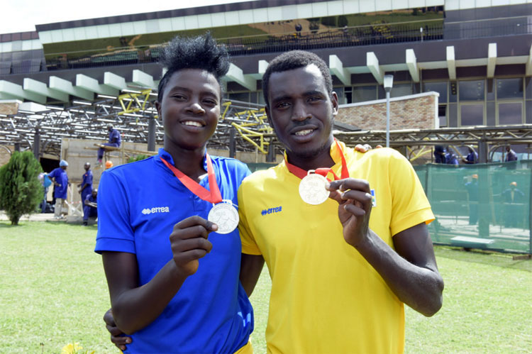 Jeanne d'Arc Girubuntu, left, and Valens Ndayisenga pose with their medals after arriving at Kigali International Airport last year. / File