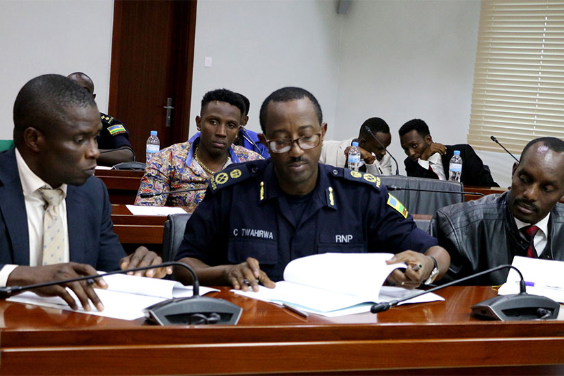 ACP Celestin Twahirwa and Ally Hussein Muganga sign the MoU as Mufuruki (R) looks on. / Courtesy