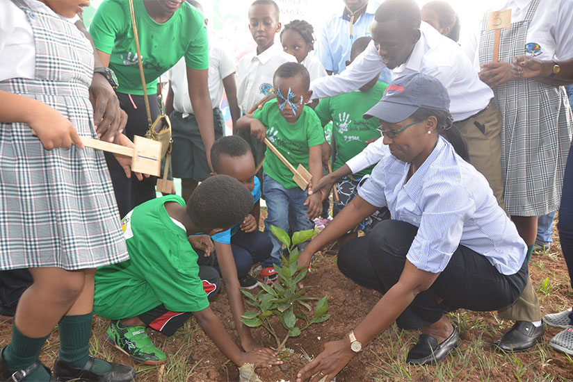 Eng. Ruhamya (R) joins children in a tree-planting exercise in Kigali on Saturday. / Sam Ngendahimana