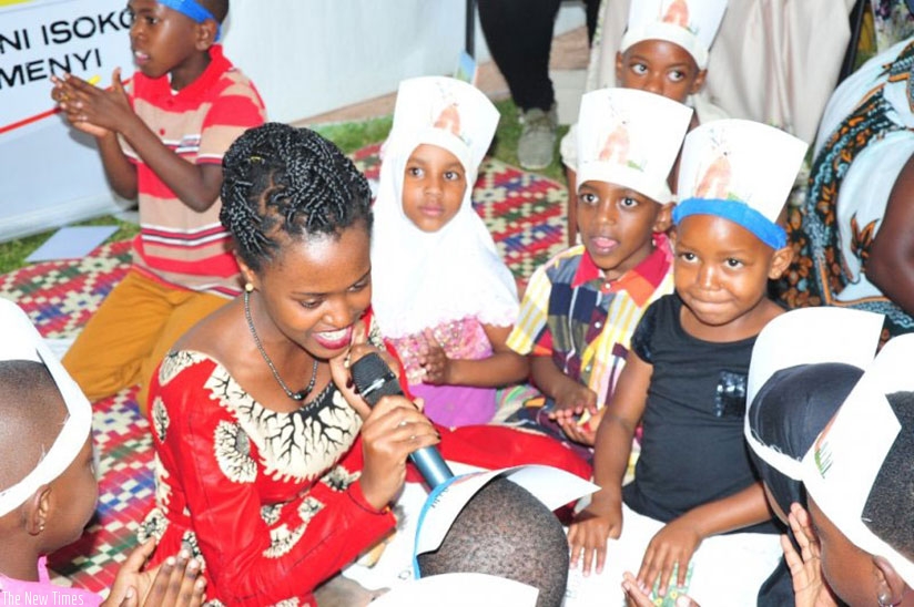 Densye Umuhoza, a local book author reading one of her books to children at Kids Land in Kisementi, Kigali. Lydia Atienornrn