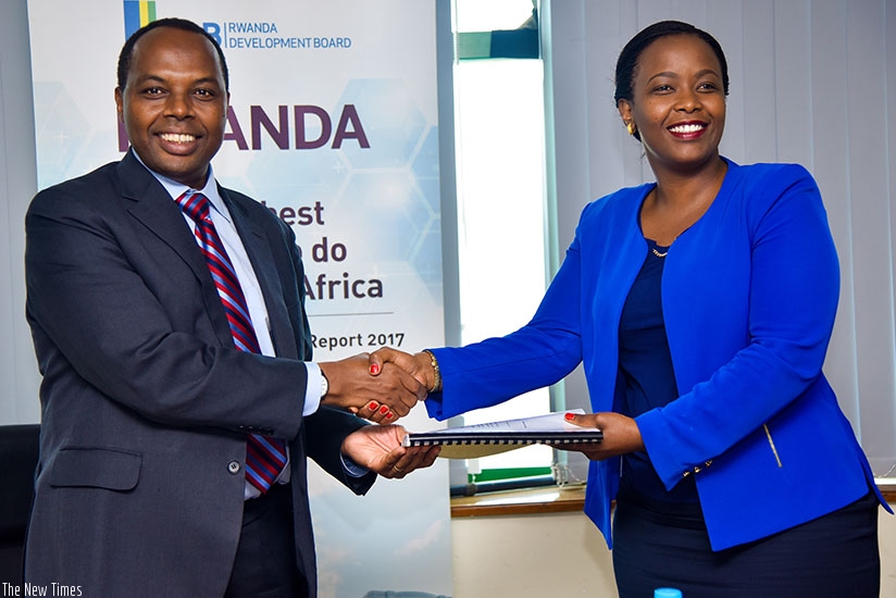 Francis Gatare hands over to Clare Akamanzi, the new CEO Rwanda Development Board. (Photos by Faustin Niyigena)